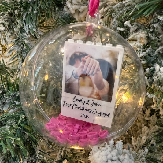 Clear Christmas ornament with a photo and text on a decorated tree
