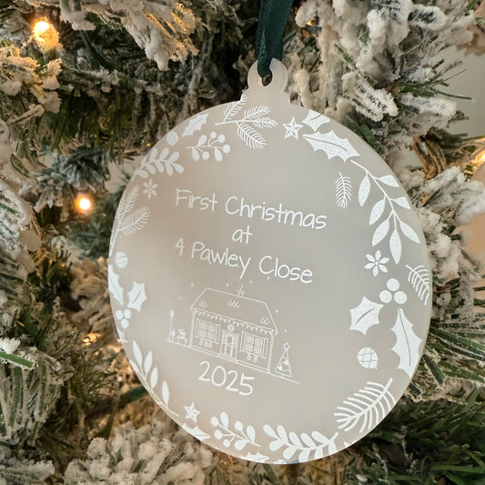 Decorative Christmas ornament with 'First Christmas at 4 Pawley Close 2025' text on a tree.