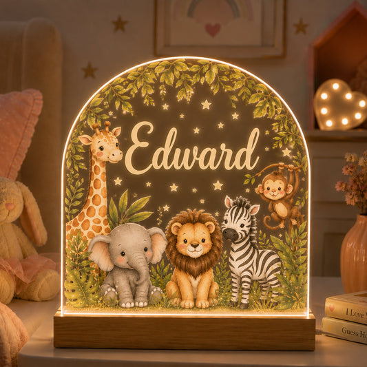 A personalized LED light table featuring safari animals including a giraffe, elephant, lion, zebra, and monkey under a leafy arch with the name 'Edward' in script, shown in a cozy child's bedroom setting.